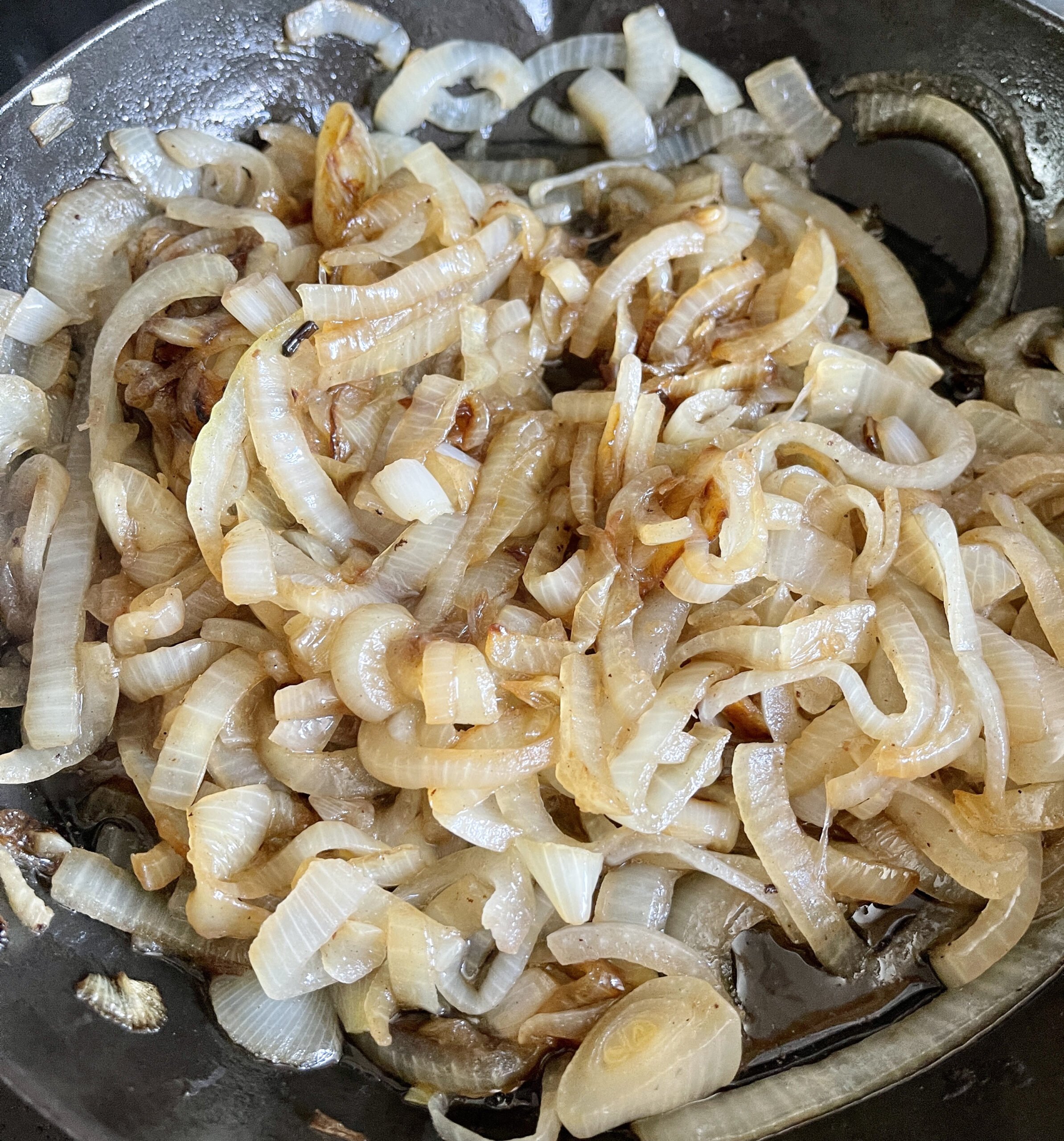 ONIONS COOKING DOWN TO CARAMELIZE