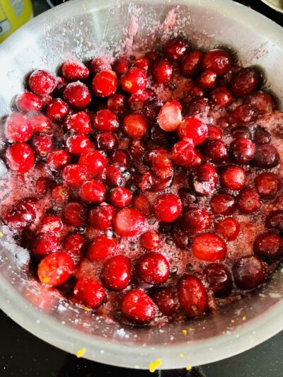Fresh whole cranberries with sugar, lemon juice, orange juice and zest and vanilla extract
